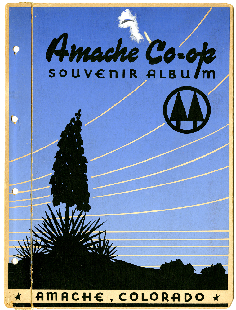 A blue print with silhouettes of trees, bushes, and barracks on the front. Reads "Amache Co-op Souvenir Album."