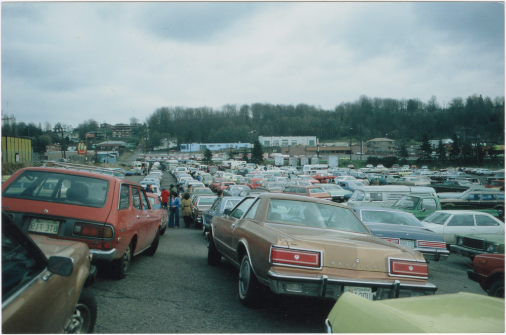 Image of several dozen cars in a lot.