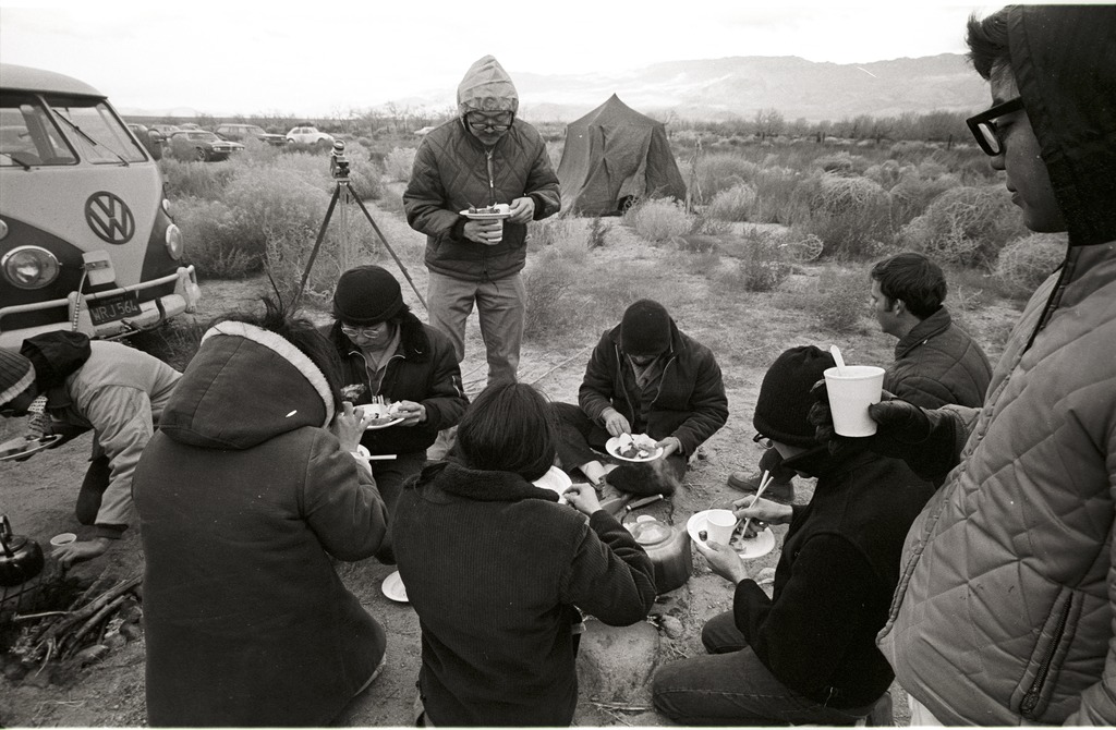 People eating next to a VW bus during the pilgrimage.