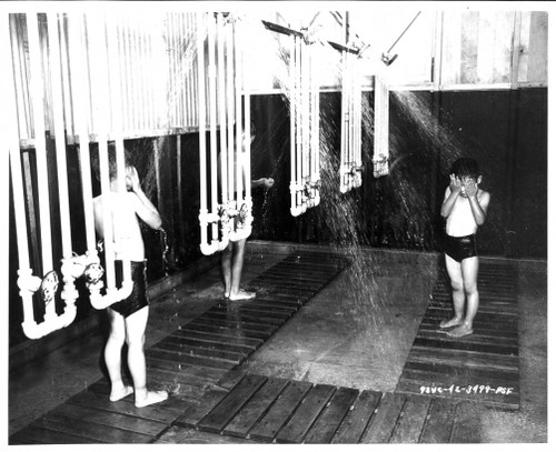 Three boys using the communal shower facilities in Fresno Assembly Center.