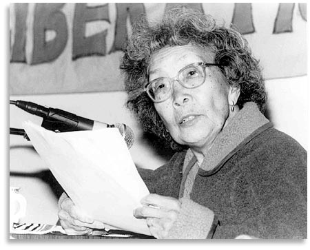 Yuri Kochiyama speaking into a microphone.